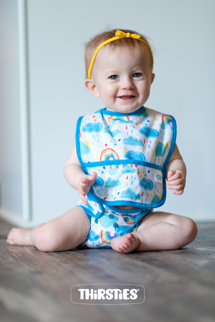 baby wearing thirsties pocket bib and matching cloth diaper