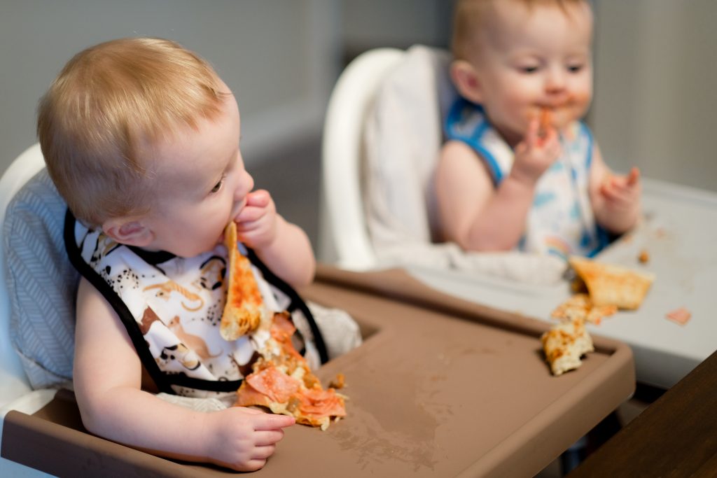 babies eating pizza wearing Thirsties pocket bib