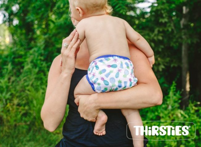 image of adult holding baby in a diaper