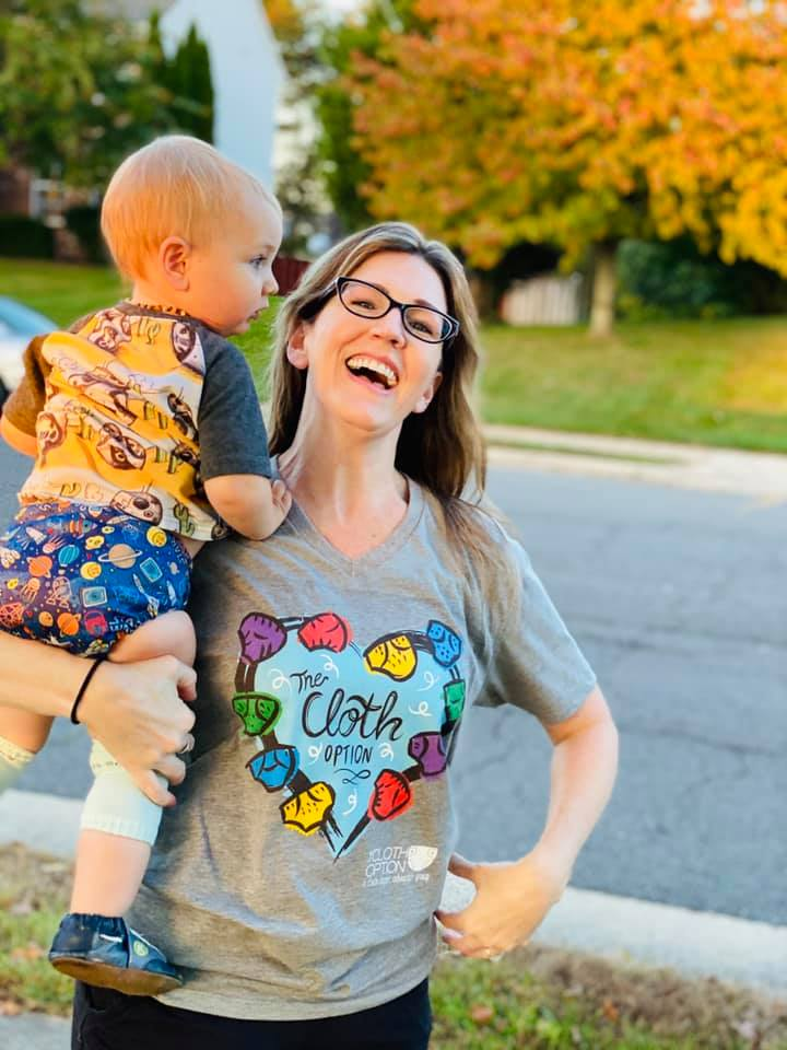 laughing baby being held by woman outside