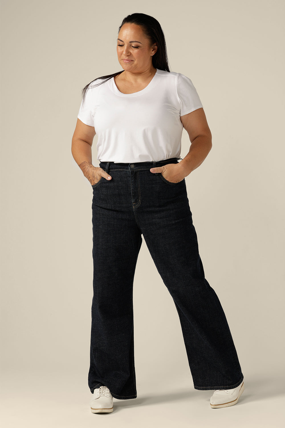 Ethical and sustainable jeans made for women in sizes 8 to 24, these jeans are high-waisted, with flared legs. Worn here in a size 16, these conscious jeans by Australian and New Zealand women's clothing brand, L&F are tailored to fit women's curves.