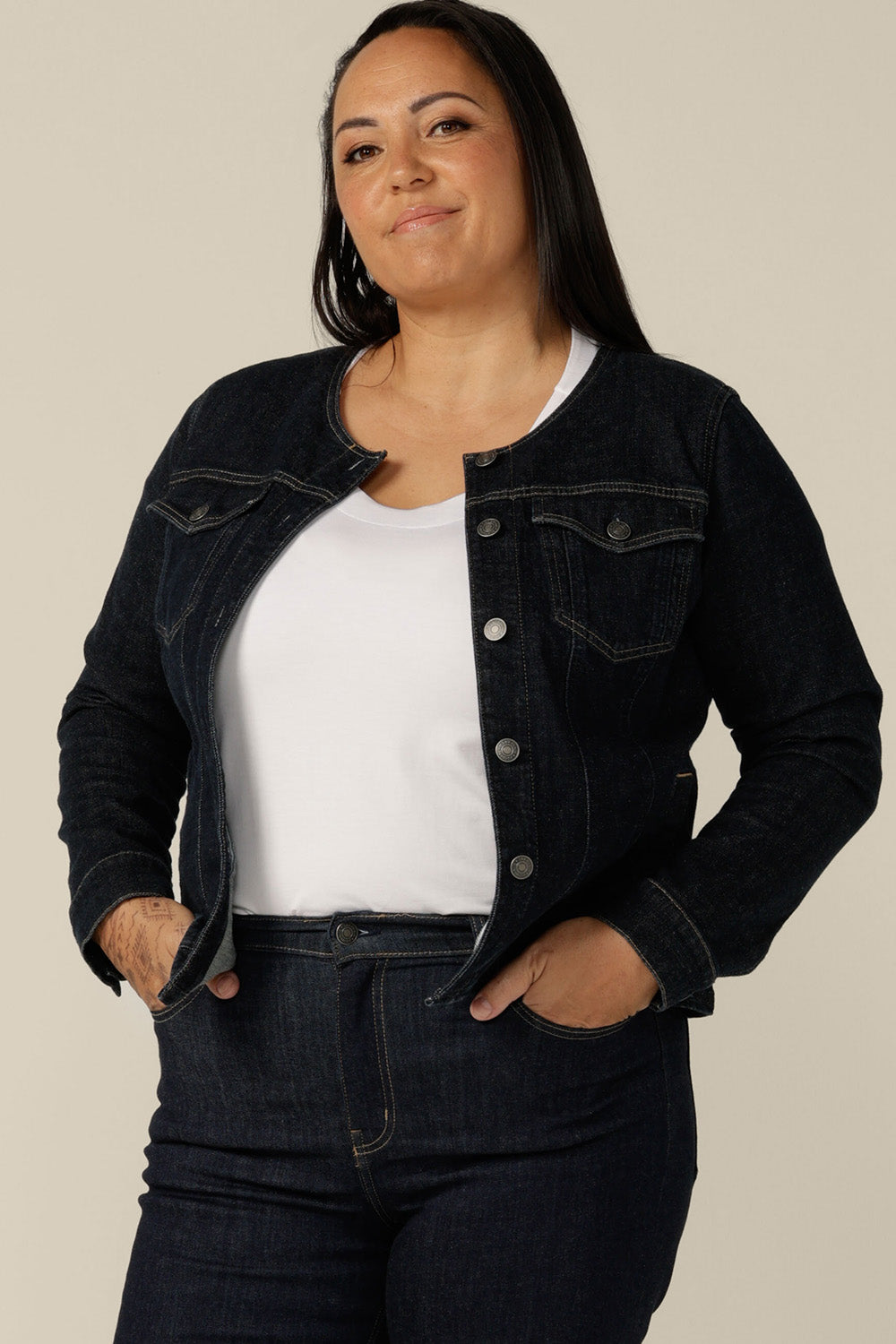 A collarless denim jacket in size 18 is worn with white bamboo jersey T-shirt and super-stretch skinny jeans. Ethical and sustainable, this denim jacket is tailored to fit women in sizes 8 to 24 by Australian and New Zealand women's clothing experts, L&F.