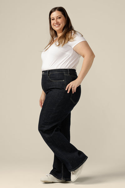 Ethical and sustainable jeans made for women in sizes 8 to 24, these jeans are high-waisted, with flared legs. Worn here in a size 16, these conscious jeans are tailored to fit women's curves. 