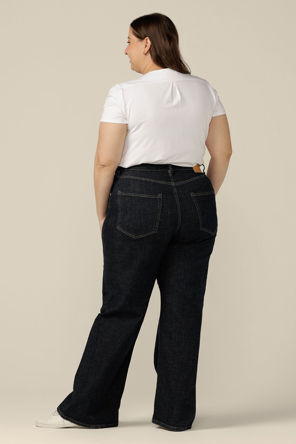 Back view of ethical and sustainable jeans made for women in sizes 8 to 24, these jeans are high-waisted, with flared legs. Worn here in size 16, these conscious jeans by Australian and New Zealand women's clothing label, L&F are tailored to fit women's curves.