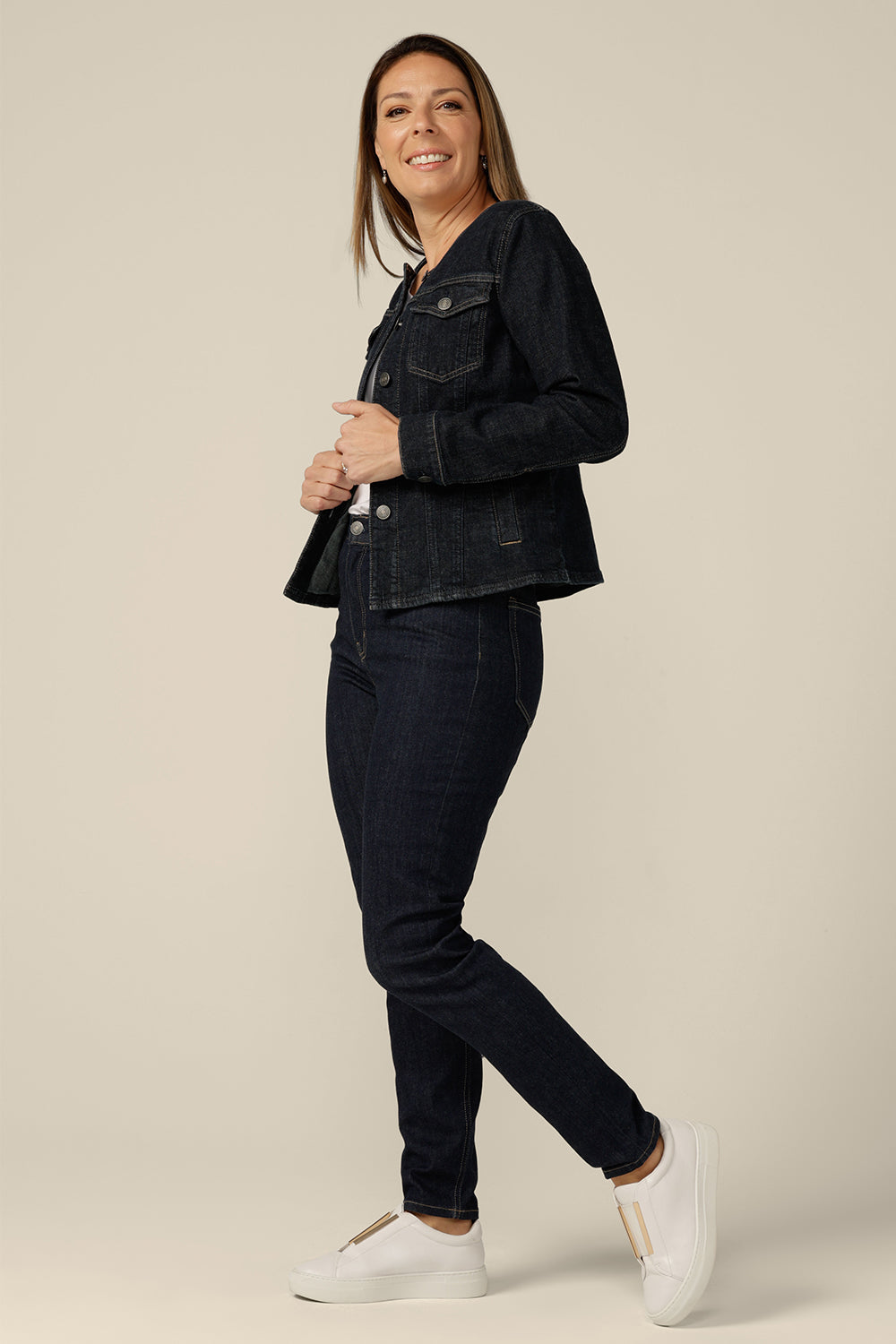 A collarless denim jacket in size 8 is worn with white bamboo jersey top and super-stretch skinny jeans. Ethically made in collaboration with Outland Denim, this denim jacket is tailored to fit women in sizes 8 to 24 by Australian and New Zealand women's clothing label, L&F.