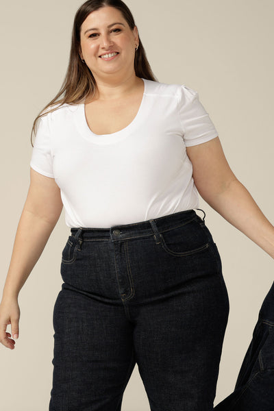 Ethical and sustainable jeans made for women in sizes 8 to 24, these jeans are high-waisted, with flared legs. Worn here in a size 16, these conscious jeans are tailored to fit women's curves.