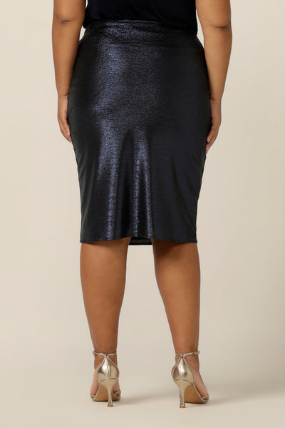 The back view of the glitzy skirt for cocktail and event wear, the Brooke Tube Skirt by Australian and New Zealand womenswear brand, L&F glitters in midnight blue jersey. A pull-on pencil skirt, the Brooke Tube Skirt's stretchy fabric makes for comfortable evening dress. Shop this cocktail dress look in sizes 8 to 24.
