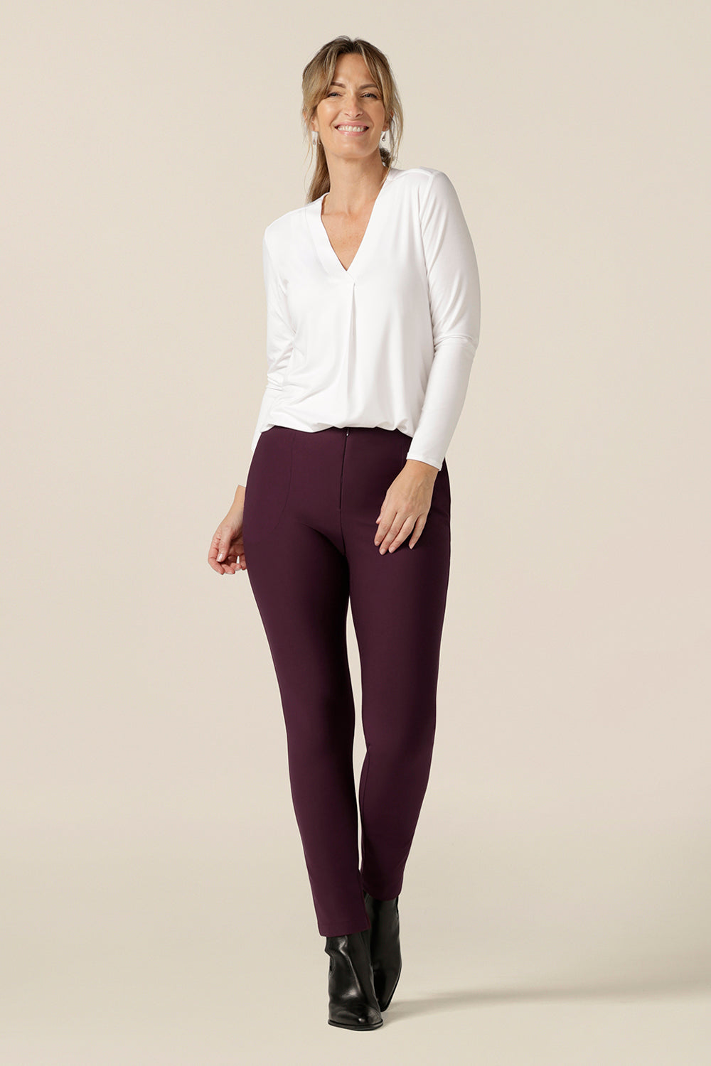 A great top for work or casual wear, this long sleeve, V-neck top in white bamboo jersey is a wardrobe essential that will match with your capsule wardrobes. worn with slim leg pants in Mulberry, this white workwear top is made in Australia by Australian and New Zealand women's clothing brand, L&F.