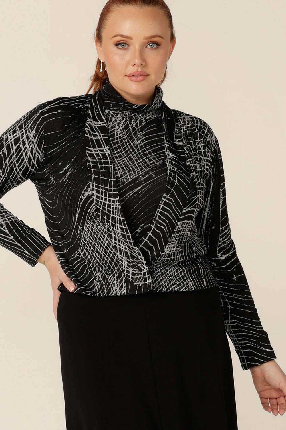A blend of jacket and cardigan, this textured knit 'jacardi' is a good way to layer up for winter. Worn by a size 12 woman, this knit jacket is worn with a matching polo neck top to create a modern twinset. Shop this jacket now in an inclusive 8 to 24 size range.
