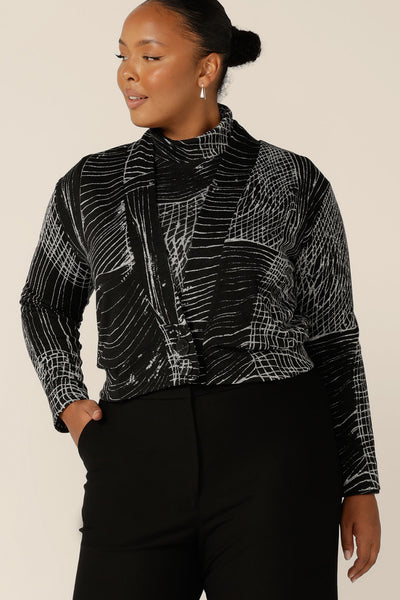 A blend of jacket and cardigan, this textured knit 'jacardi' is a good way to layer up for winter. Worn by a plus size, size 18 woman, this knit jacket is worn with a matching polo neck top to create a modern twinset for work wear and weekend wear.  