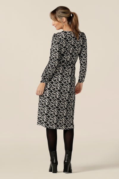 Back view of a great work dress with long sleeves. This wrap dress with tulip skirt by Australian and New Zealand women's clothing label, L&F is worn by a size 10 woman. This jersey wrap dress is available in inclusive sizes, 8 to 24.