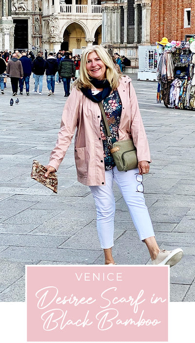 Loyal customer of Australian and New Zealand women's clothing label, elarroyoenterprises, Susan wears her bamboo jersey, black scarf and long sleeve floral print top on holiday in Venice, as part of her guide on what clothes to pack for the ultimate capsule travel wardrobe.