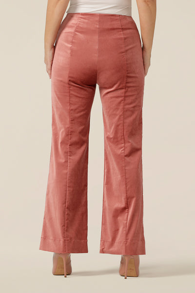 Back view of event and occasionwear, tailored,  flared pants fro women in musk pink velveteen. Made in Australia by Australian and New Zealand women's clothing label, L&F, these special event pants are available to shop in sizes 8 to 24, petite to plus sizes.