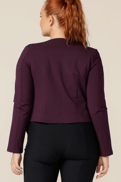 Back view of a good workwear jacket, the Mackenzie Jacket in Mulberry by Australian and New Zealand women's clothing brand, L&F is a collarless, open front jacket with long sleeves and an angled hem. Made in Australia, shop this corporate wear jacket in an inclusive size range of 8 to 24. 