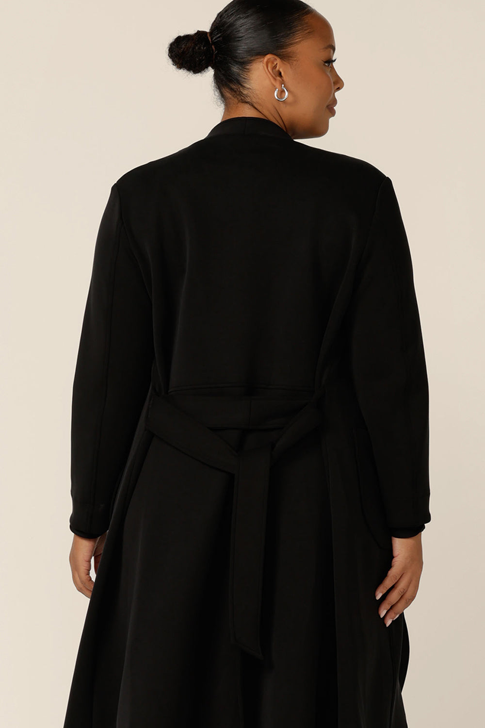 Back view of a softly tailored black trenchcoat in modal fabric, made in Australia by Australian and New Zealand women's clothing brand, L&F.