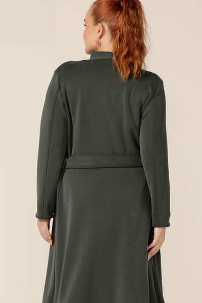 A classic winter coat for women, the Marant Trenchcoat in Sage green by Australian and New Zealand women's clothing brand, L&F is shown in a size 12. A back view of the collarless, open fronted coat with tie belt and patch pockets, this women's winter coat is made in Australia.