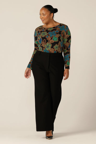 A fuller figure, size 18 woman wears a boat neck jersey top with long sleeves worn with black wide leg pants. Both top and pants are made in Australia by Australian and New Zealand, size inclusive women's clothing brand, L&F.