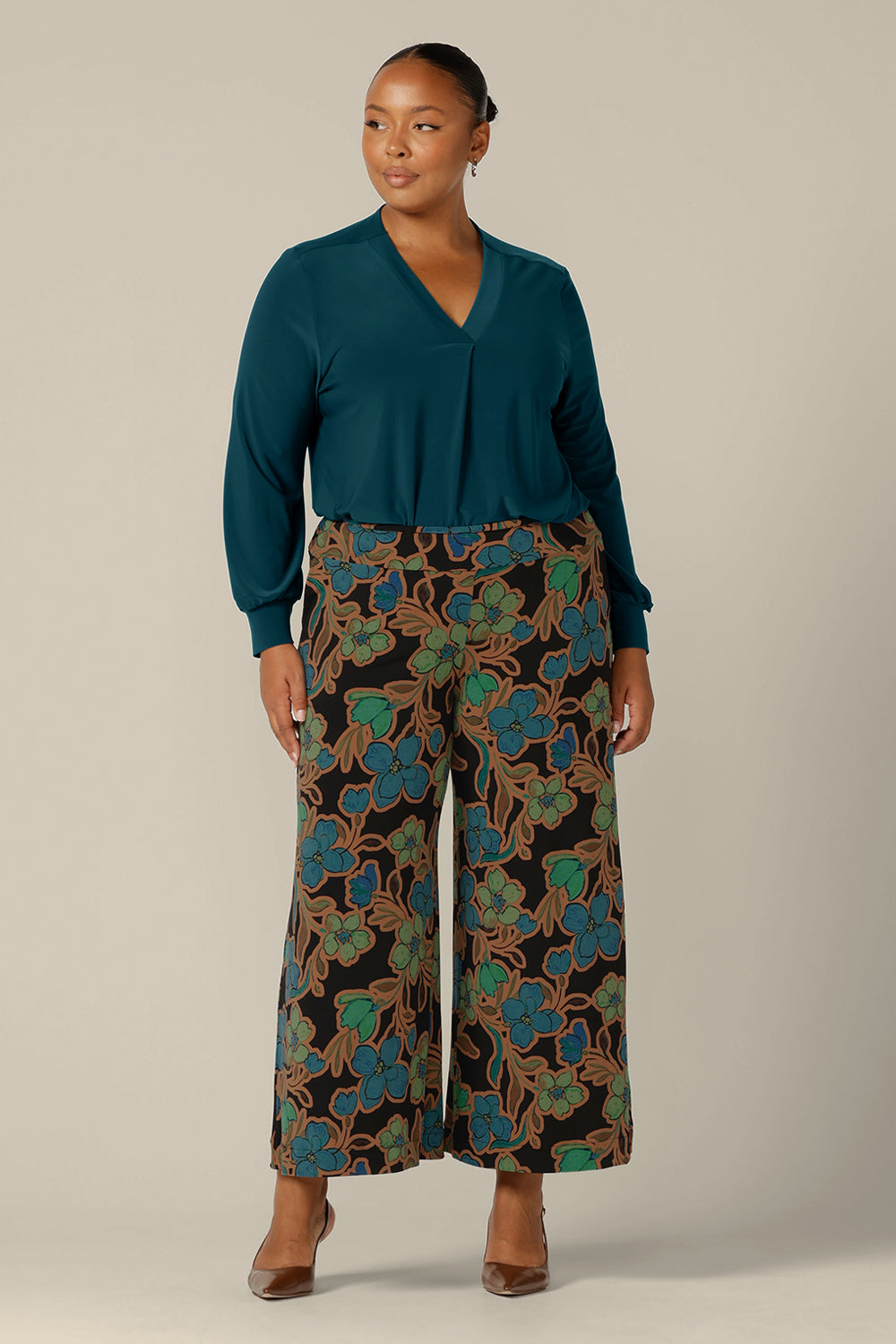 Long sleeve, V-neck top in dark teal jersey, size 18 worn with wide leg, printed pants. Both are made in Australia by Australian and New Zealand women's clothing company, L&F. 