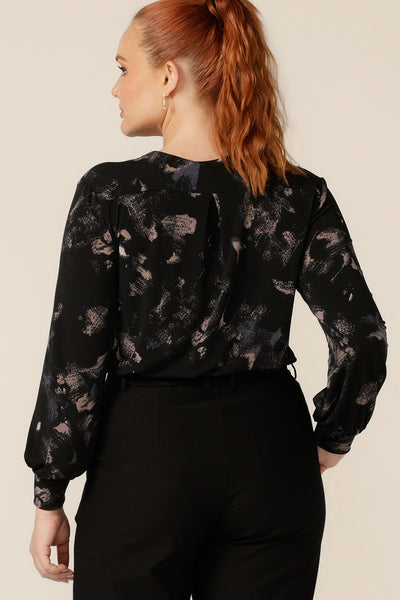 Back view of a long sleeve, V-neck top in printed black jersey, size 12. Made in Australia by Australian and New Zealand women's clothing label, L&F, this comfortable top is available in sizes 8 to 24.