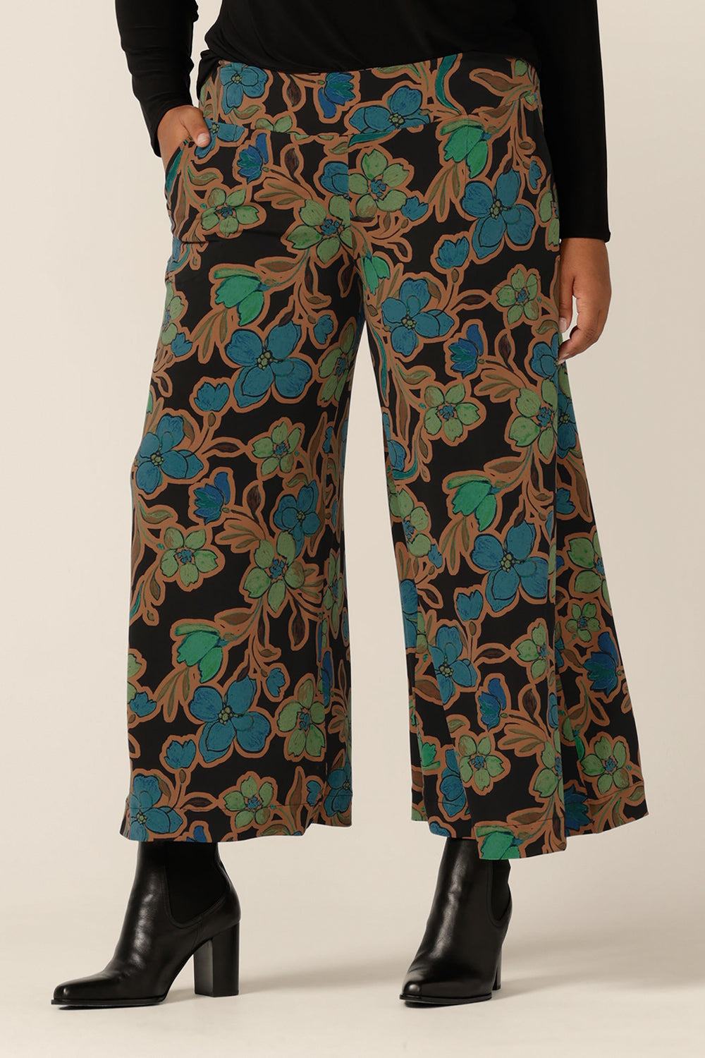 The Presley Pants in Secret Garden - a mid-rise, pull-on pant with wide legs and stretch jersey fabrication, worn with a long sleeve black top. Made in Australia by women's clothing label L&F. Shop size inclusive trousers in sizes 8 to 24 now.