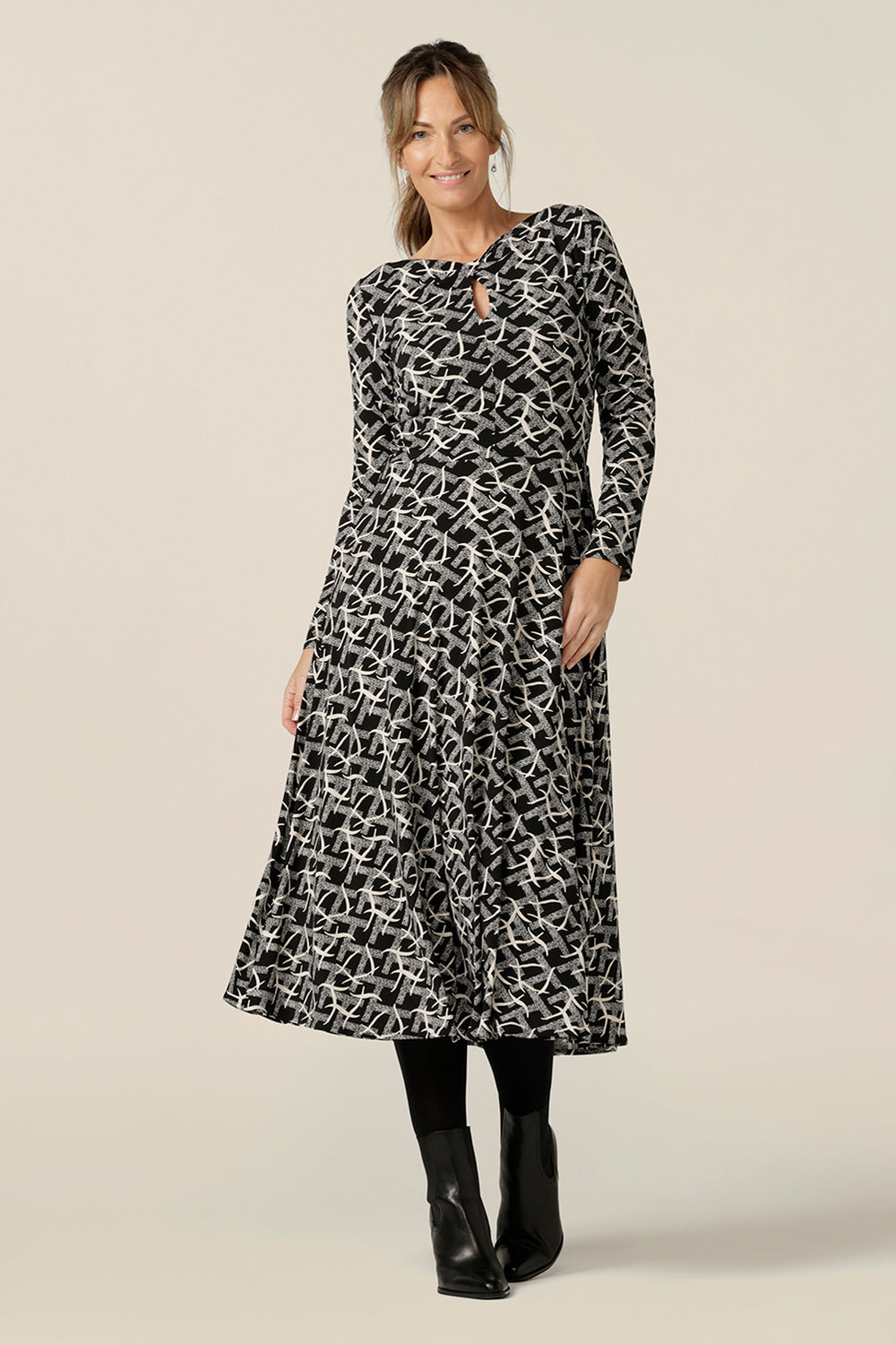 A size 10  woman wears a midi length, long sleeve dress with twisted keyhole detail. Made by Australian and New Zealand women's clothing label, L&F in an inclusive size range of sizes 8 to 24.