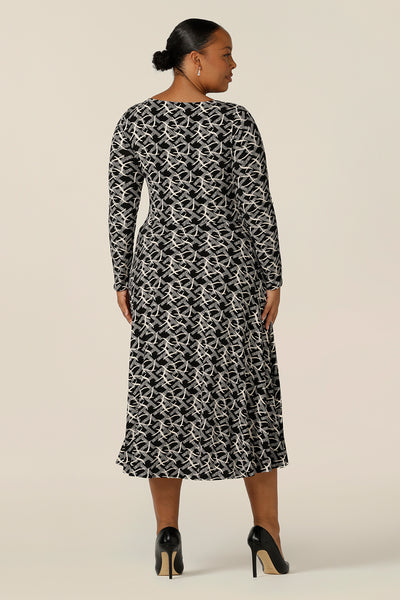 Back view of a good dress for plus size, fuller figure women, the Sandee Dress in Thornbirds by Australian and New Zealand women's clothing company L&F is well-fitting in a black and white print jersey fabric. A midi length, long sleeve dress with twisted keyhole detail, this is an Australian-made dress available to buy in an inclusive size range of 8 to 24.