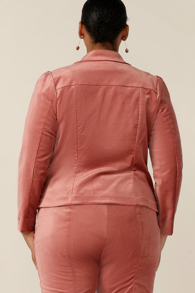 Back view of a tailored occasionwear jacket for women with a single-button fastening, collar and notch lapels and tailored fit. In musk pink Velveteen, this suit jacket has the look and feel of a velvet jacket - perfect for cocktail party wear and eveningwear! 