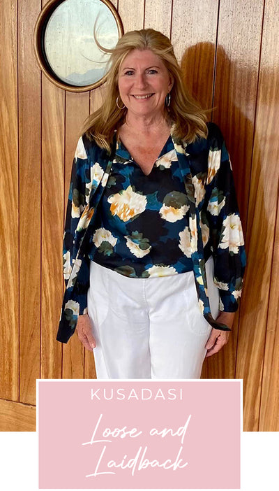 Loyal customer of Australian and New Zealand women's clothing label, elarroyoenterprises, Susan wears a floral print, satin rayon shirt with tie neckline and long bishop sleeves as going out to dinner wear on a European cruise holiday, as part of her guide on what clothes to pack for the ultimate capsule travel wardrobe.