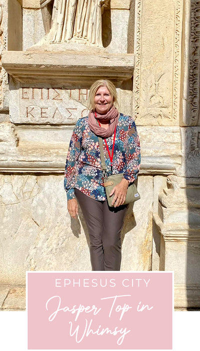 Loyal customer of Australian and New Zealand women's clothing label, elarroyoenterprises, Susan wears olive, slim pants and long, bishop sleeve jersey top in pretty floral print, and pink bamboo jersey scarf in Ephesus Ancient City, as part of her guide for 40 plus women on what clothes to pack for your travel holiday.