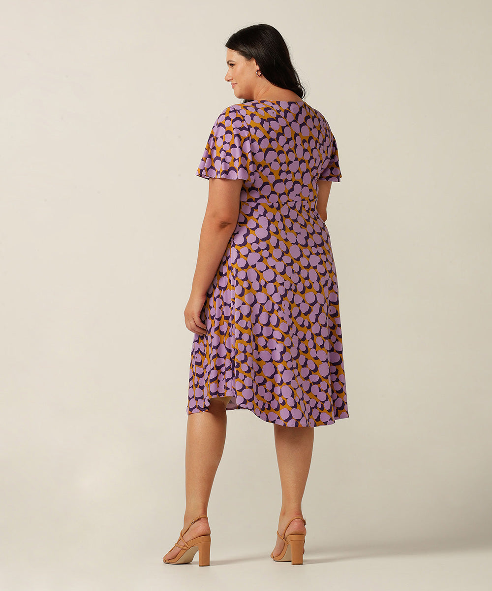 twist front, empire line short dress with flutter sleeve. Made in Australia for plus size women, petite sizes and women looking for evening, occasionwear and party dresses.