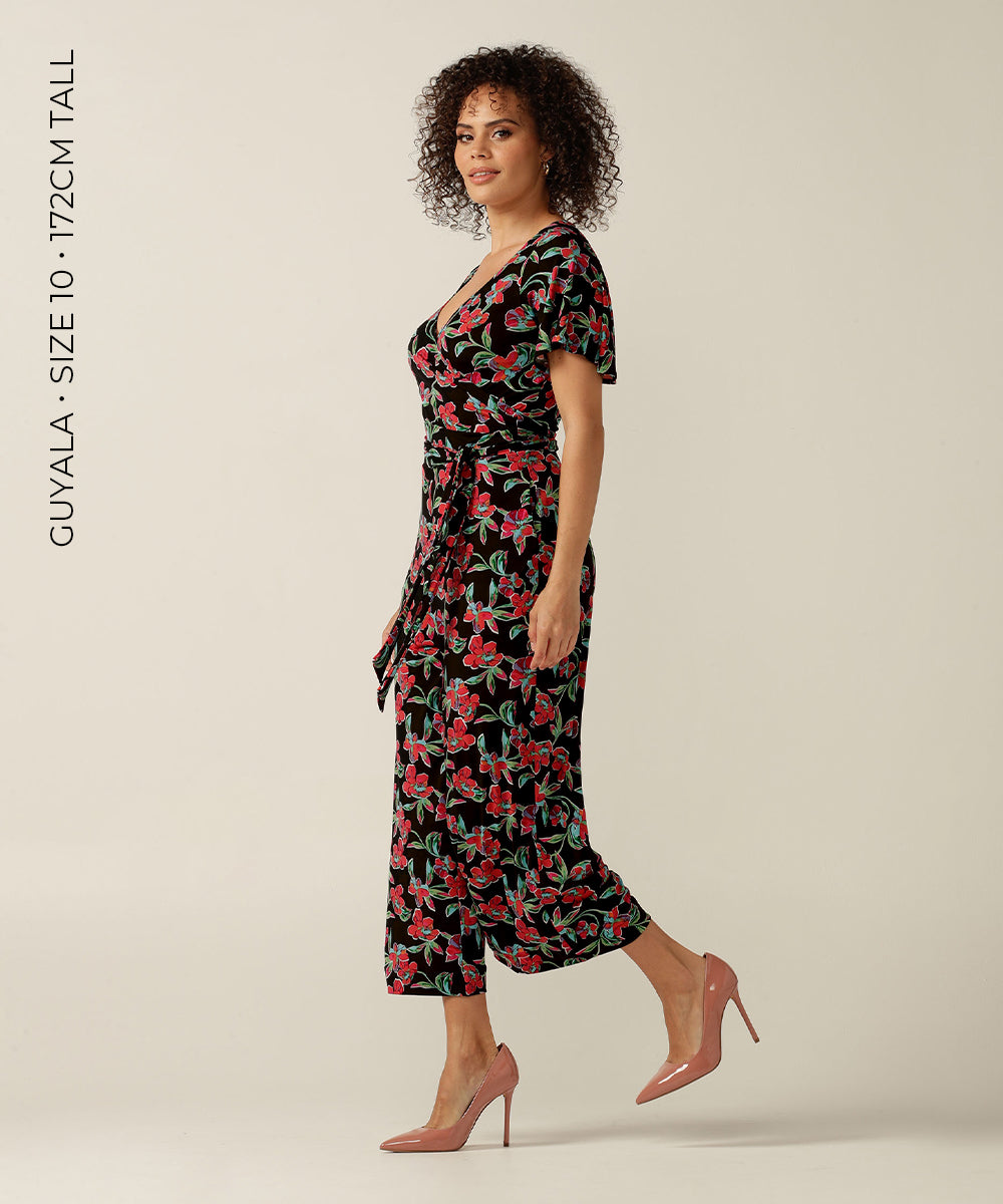 Wrap-front stretch jersey jumpsuit with short flutter sleeves and wide cropped legs. Featuring an exclusive colourful floral print, this jumpsuit is made in Australia for plus size women, petite women and women looking to build a capsule wardrobe.