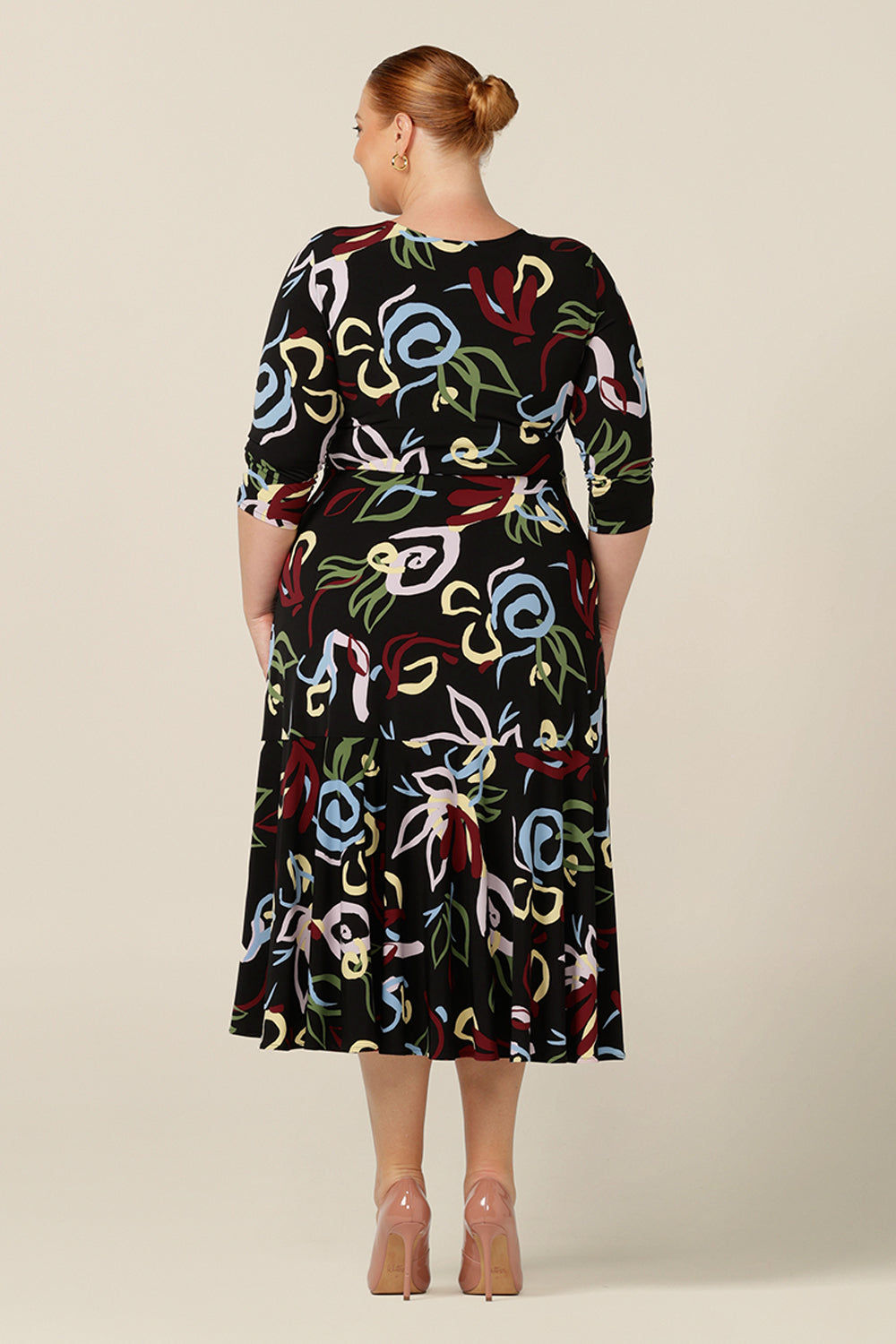 Back view of a reversible fixed wrap dress with 3/4 sleeves. Made by women's workwear experts, Australia and New Zealand fashion label, L&F, this dress can be worn with a V-neck wrap front or boat neck.