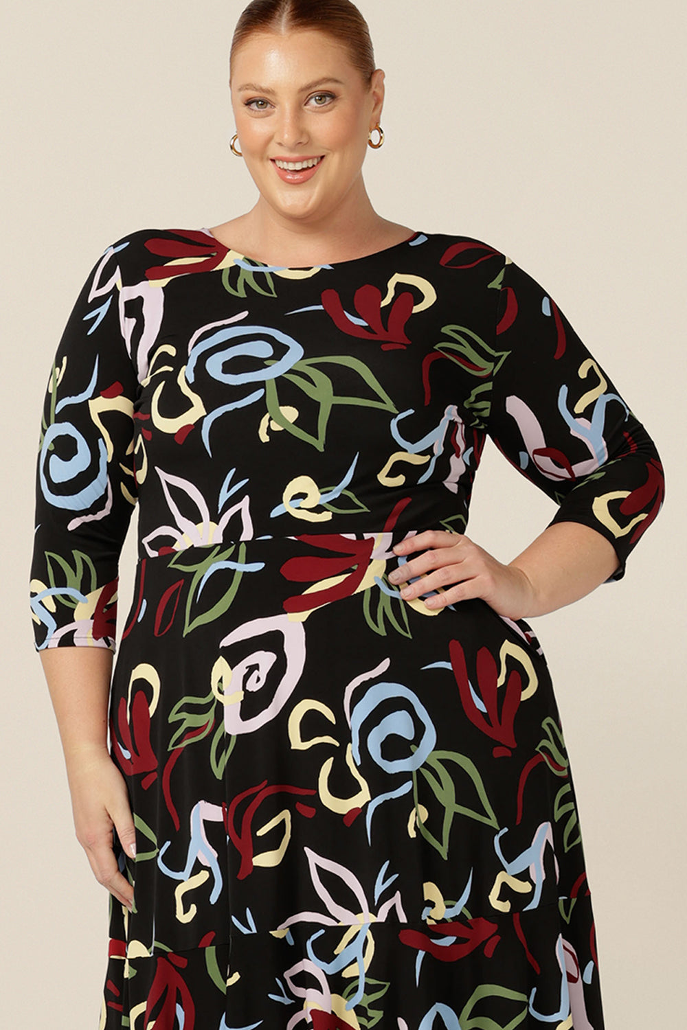 Close up view of a size 18 woman wearing a boat neck dress with 3/4 sleeves, made in Australia for petite to plus size women. 