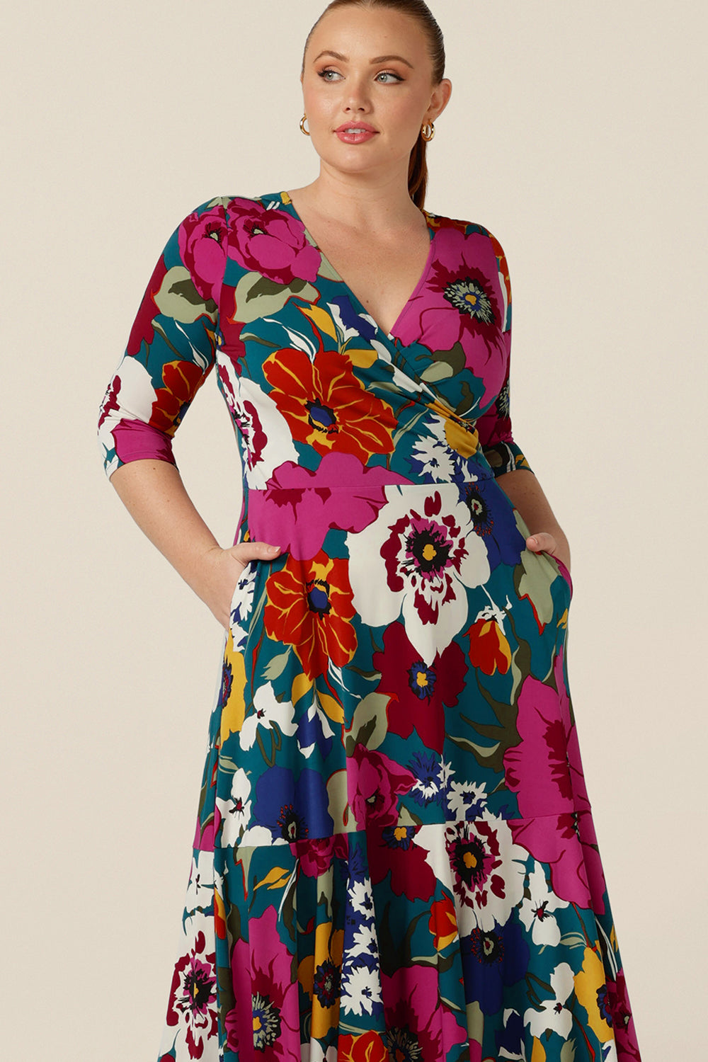 A close up of a reversible jersey wrap dress by Australian and New Zealand women's clothing company, L&F. The dress has a V-neckline, wrap front, 3/4 sleeves and side pockets in her full maxi skirt.
