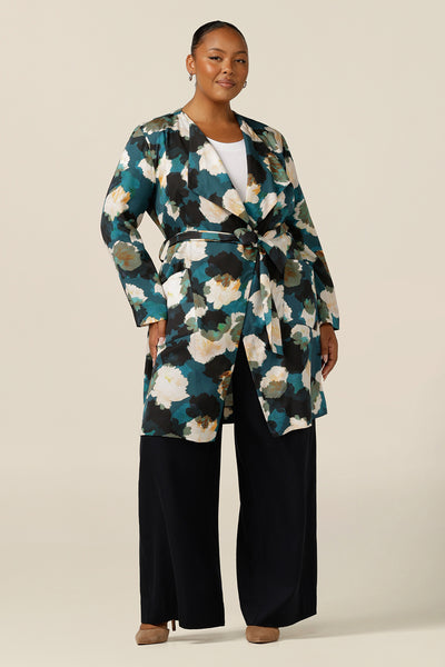 a size 18, plus size woman wears the best luxury jacket for autumn/winter 2023. In sustainable Tencel fabric, this jacket's floral print (designed exclusively for Australian-made women's clothing company L&F) is on a teal base with white and navy flowers. A luxury long jacket, shop it in plus sizes for fuller figures online at leina and fleur. 