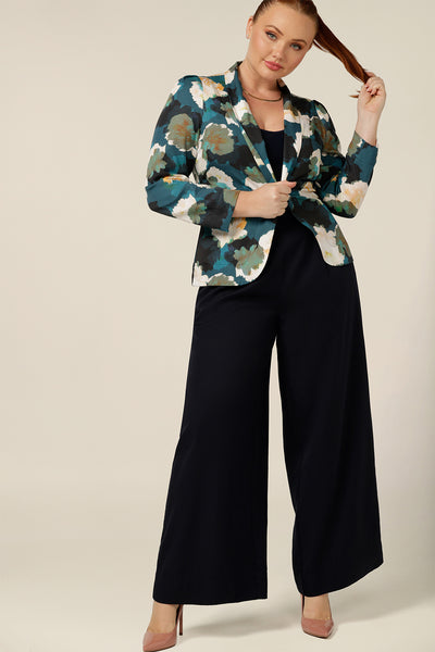 a size 12, curvy woman wears a blazer-style jacket with tuxedo collar. A luxury jacket, shop it in petite to plus sizes for fuller figures online at Australian and new zealand women's clothing brand, leina and fleur. 