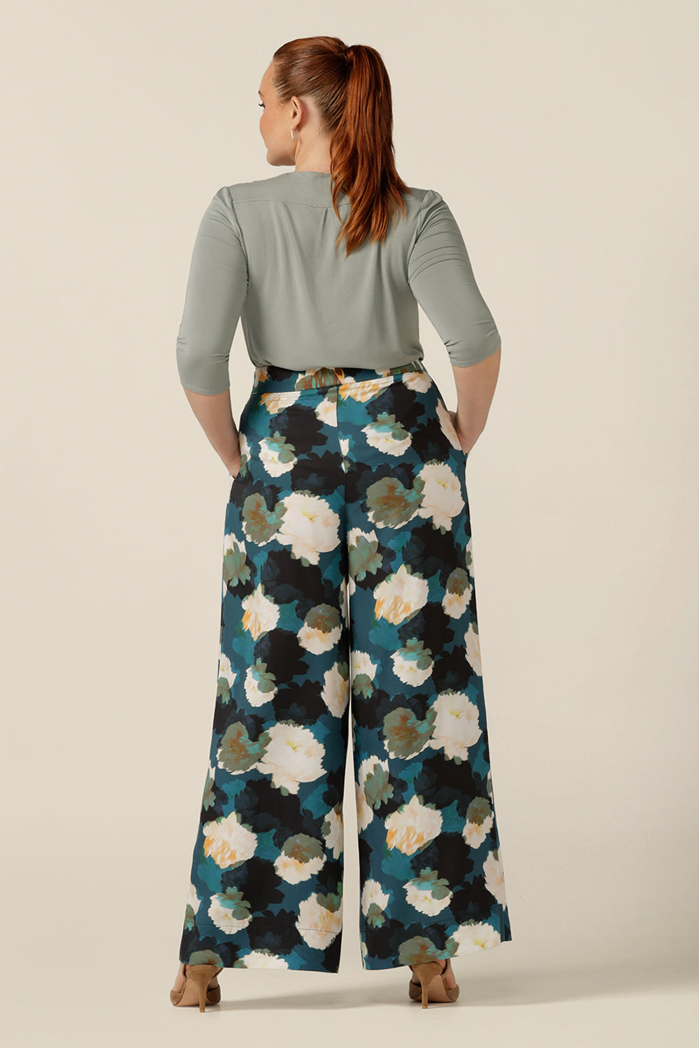 Wide-leg, high-waisted smart printed pants are worn by a size 12, curvy woman. Part of Australian and New Zealand women's clothing label, L&F's focus on sustainable fashion, these work wear trousers are eco-conscious in Tencel fabric. Worn with a casual bamboo jersey top, the Australian-made pants look smart-casual for workwear and beyond!