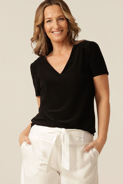 tailored short sleeve top with v-neckline and shirttail hemline