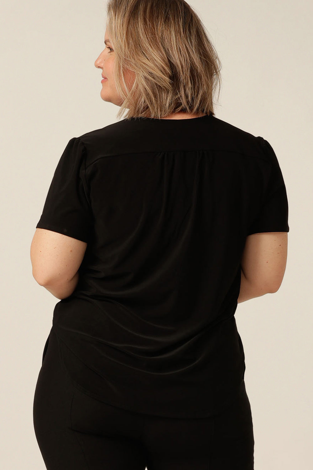 tailored short sleeve top with v-neckline and shirttail hemline