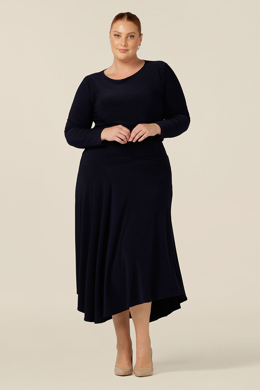 Layered with a navy top for a faux dress look, this pull-on skirt with midi-length, asymmetric hemline is classic for work and corporate wear or comfortable casual wear.