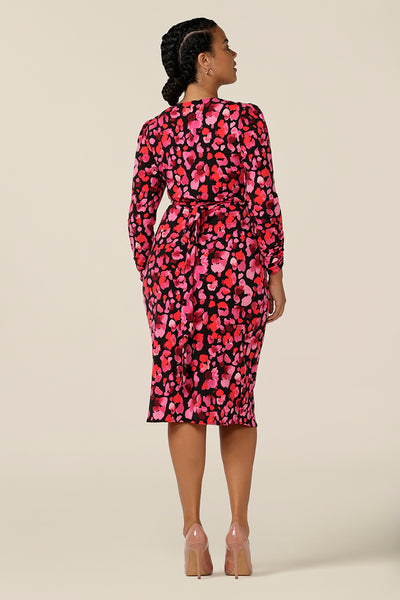 back view of a long sleeve jersey wrap dress by Australia and New Zealand women's clothing label, L&F. a classic wrap dress, her tulip skirt coordinates with her floral print to create an elegant wrap dress you can wear for work or events.  