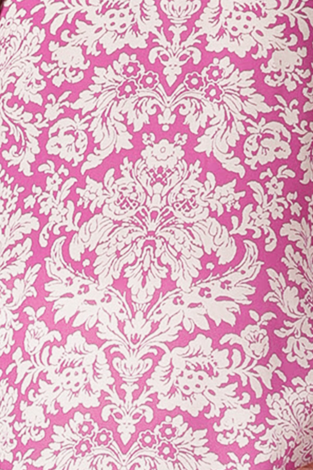 fabric swatch of white chevron print on pink background