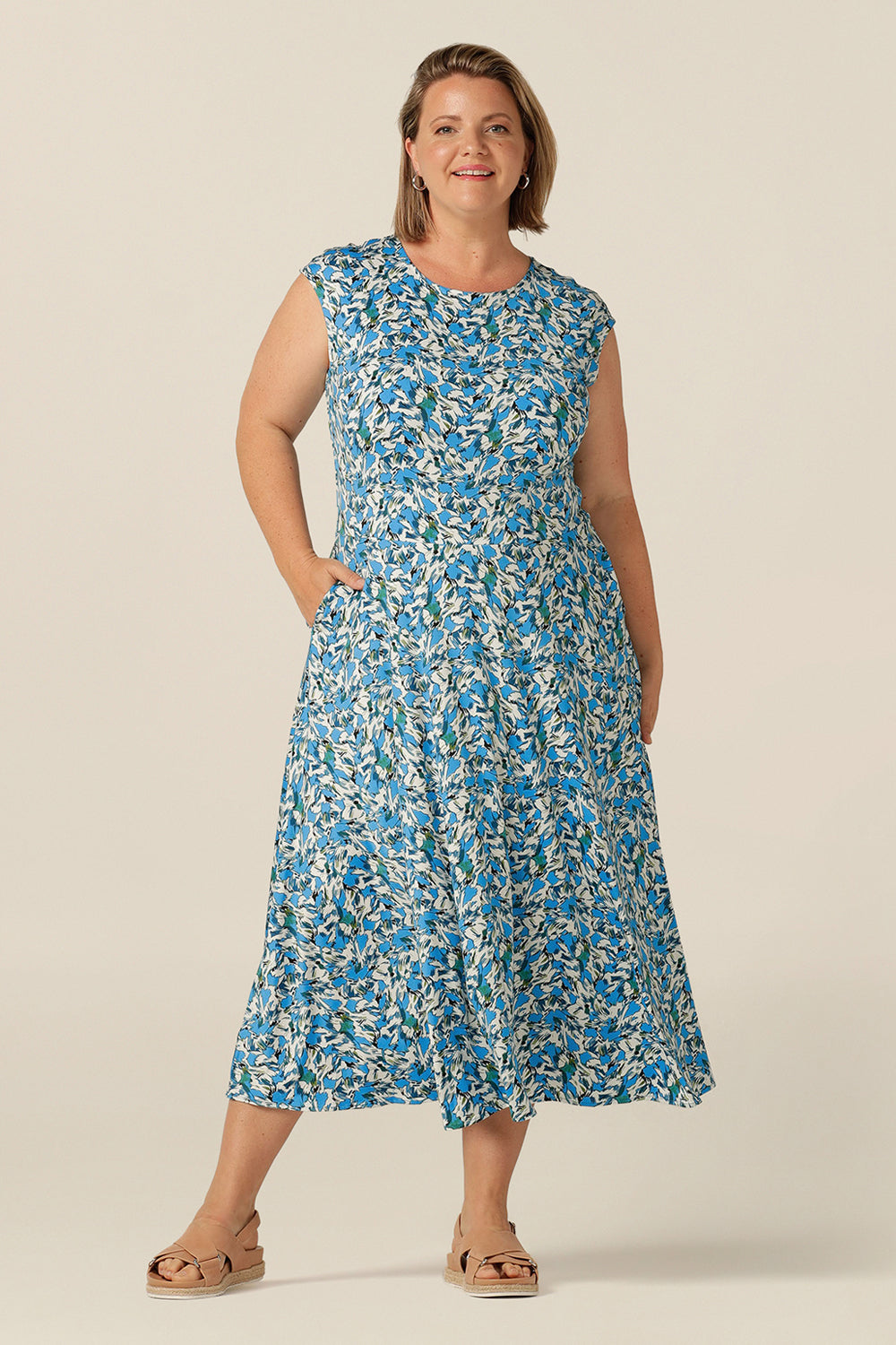 high-neck sleeveless jersey dress with calf-length full skirt and pockets