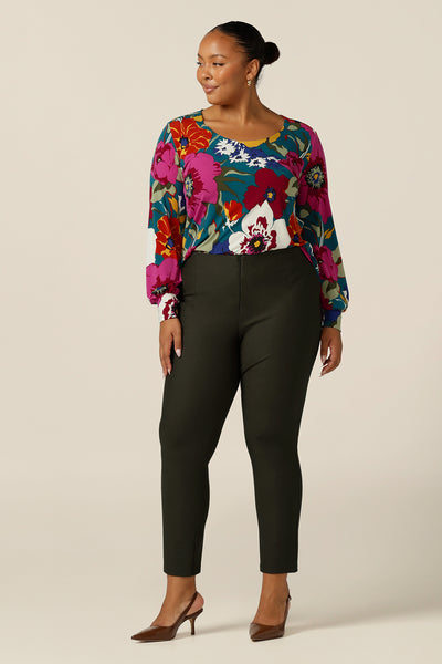 A size 18, fuller figure woman wears a scoop neck, floral print jersey top with long bishop sleeves. Made in Australia by Australian and New Zealand women's clothing brand, L&F this quality top is designed for work and casual wear.