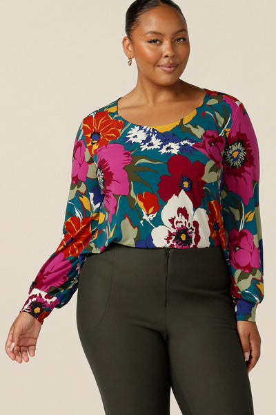A size 18, fuller figure woman wears a scoop neck jersey top with long bishop sleeves. Made in Australia, this quality top is designed for work and casual wear. 
