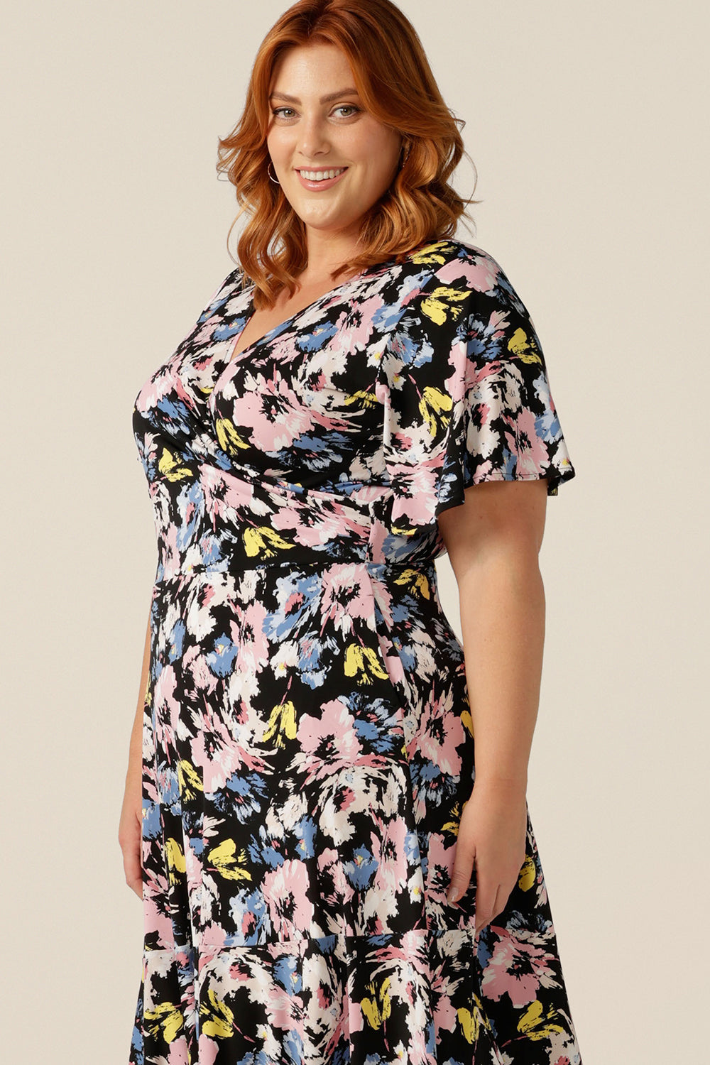 Vintage floral print dresses for women over 40, the Nicolle Reversible Dress has short sleeves and a full knee-length-skirt. A reversible dress, it can be worn as a V-neck wrap dress or backwards with a boat neckline. Well made and well-fitting in sizes 8 to size 24, shop jersey wrap dresses at Leina and Fleur online