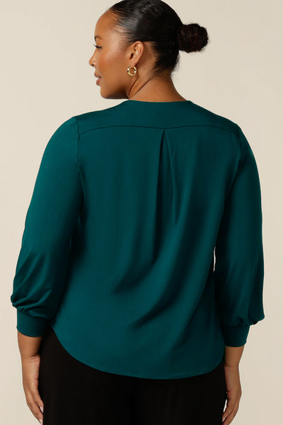 Back view of a size 18, plus size woman wearing a long sleeve, V-neck top in bamboo jersey. this top is good for work and casual wear.