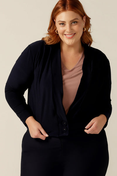 a plus size 18 woman wears a long sleeve jacket-cardigan hybrid in navy. A comfortable jacket for autumn, it made in soft jersey (and made in Australia!). 