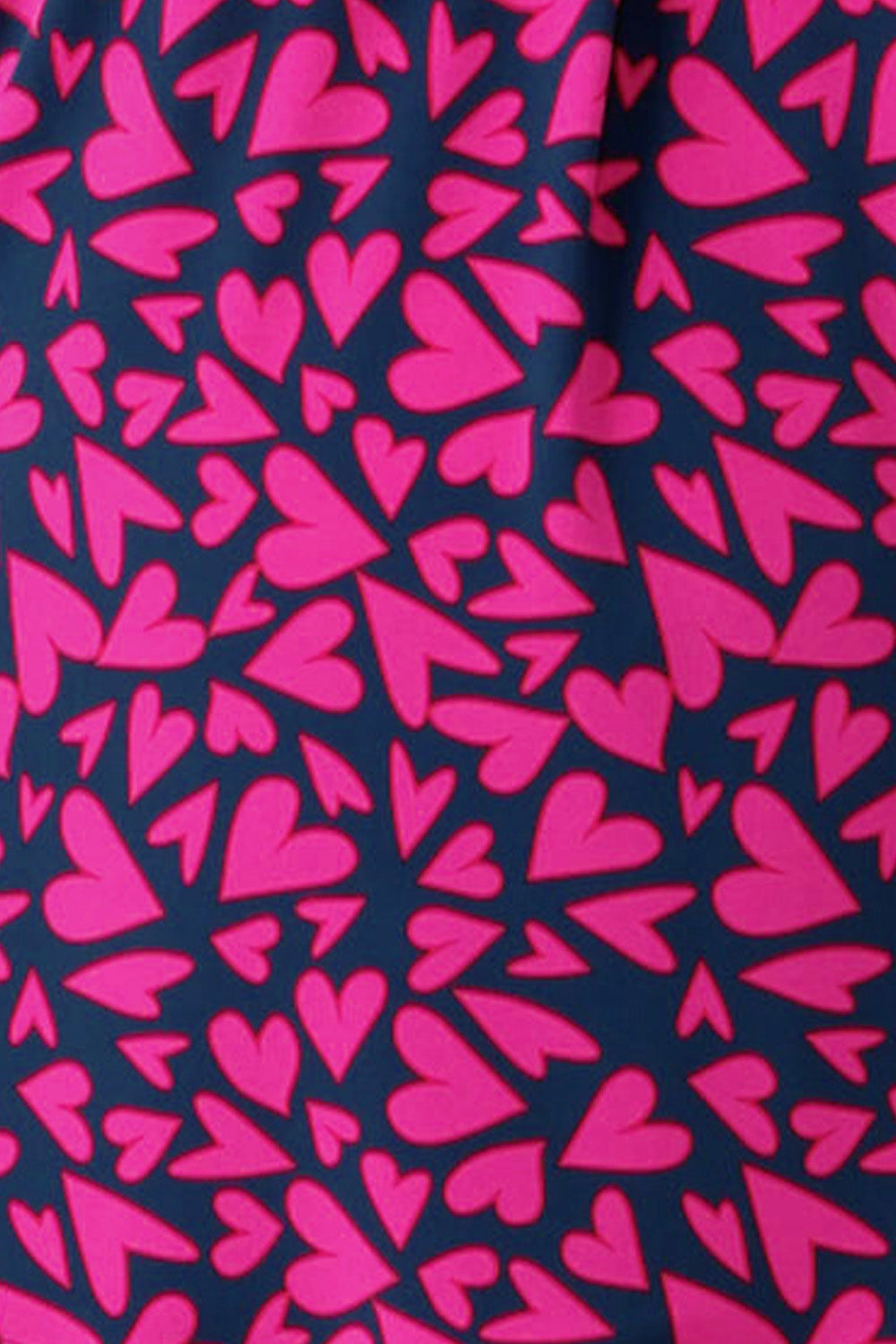 swatch of a printed jersey fabric patterned with pink hearts on a navy blue base. This fabric was designed at Leina and Fleur in Queensland, Australia and is used in their Valentine's range of woman's clothing made in Australia for petite to plus size women,