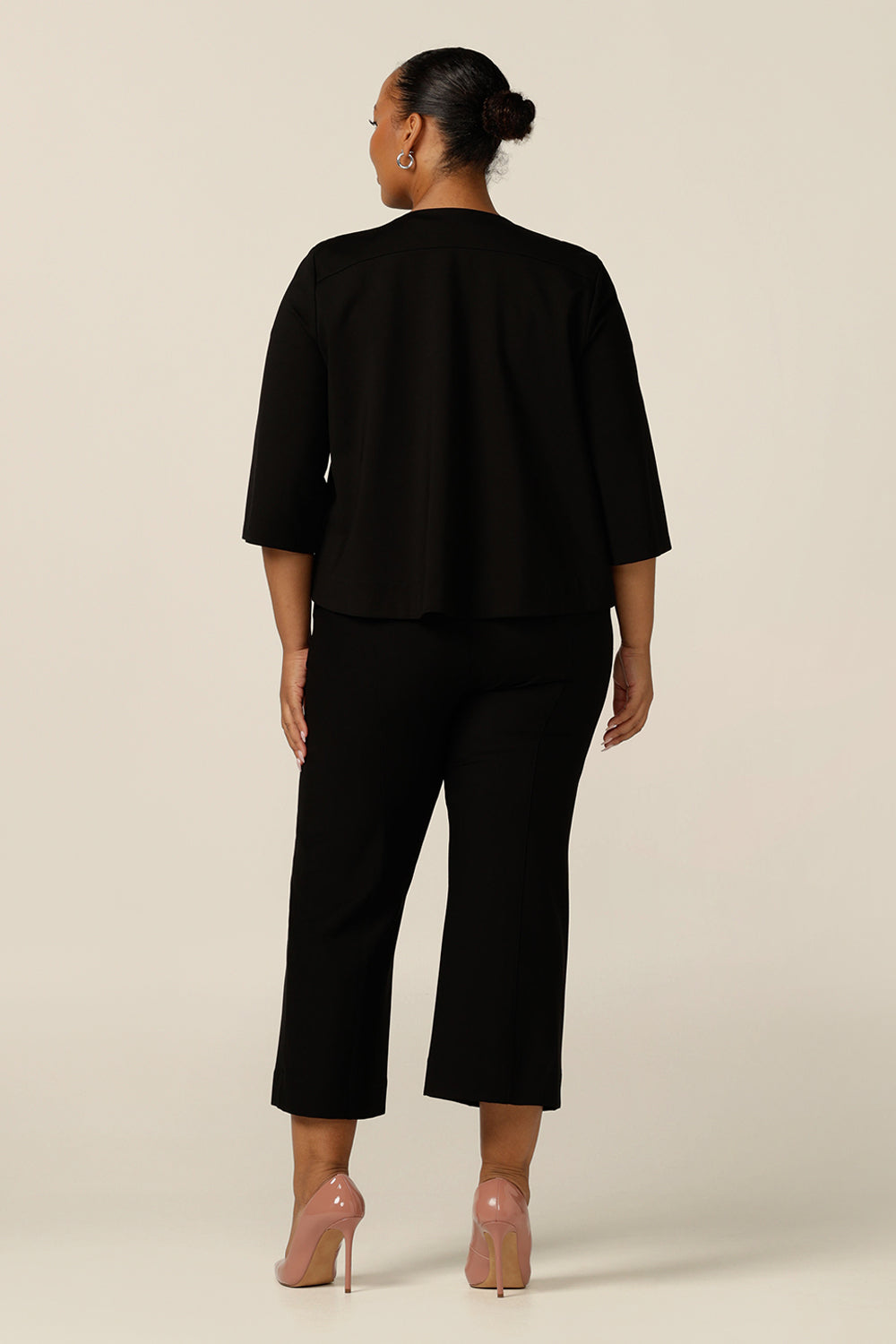 The swing back of the black ponte jersey Zander Jacket by Australian and New Zealand women's clothing brand, Leina and Fleur. The work wear jacket also features a round neckline, 2 button fastenings and 3/4 sleeves.